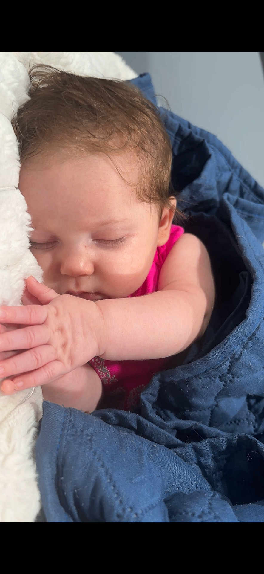 Ecxo is registered to the contest to win money with this photo: baby, sleeping, blanket, blue, cozy, child, infant, face, hand, pink_clothing, peaceful, soft_light, closeup, indoors, rest, cute, skin, hair, portrait, relaxation
