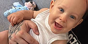 Emmett participe au concours pour gagner de l'argent avec cette photo : arm, baby, blue_eyes, child, couch, cute, diaper, face, hand, happy, holding, indoor, mickey_mouse, person, plush_toy, sitting, skin, smiling, tattoo, white_clothing