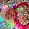 Harmony joined the competition — help win amazing prizes! baby, sleeping, santa_hat, christmas, holiday, festive, lights, string_lights, colorful, portrait, close_up, winter, red_clothing, hat, infant, peaceful, cozy, decoration, sparkles, indoor