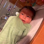 Chevelle is registered to the contest to win money with this photo: architecture, baby, bathing, blanket, building, crib, face, furniture, happy, head, hospital, infantbed, newborn, person, photography, portrait, smile