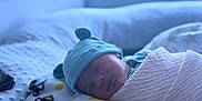 Ka'Tori joined the competition — help win amazing prizes! baby, newborn, sleeping, hat, blanket, bee_pattern, cozy, soft, indoors, resting, peaceful, infant, wrapped, cute, child, portrait, comfort, warm, headwear, bed