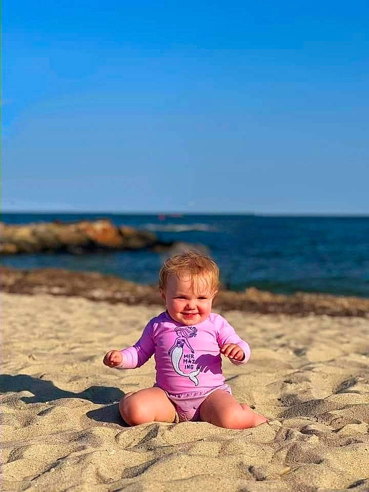 Hadley is registered to the contest to win money with this photo: azure, baby, baby_toddler_clothing, beach, child, flash_photography, fun, happy, horizon, joy, landscape, leisure, people_in_nature, people_on_beach, person, shore, sky, t_shirt, toddler, travel