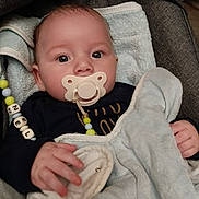 Gabriel participe au concours pour gagner de l'argent avec cette photo : baby, pacifier, blanket, beads, infant, child, cute, face, hand, seat, comfort, clothing, soft, portrait, indoors, gaze, young, cozy, wrapped, resting