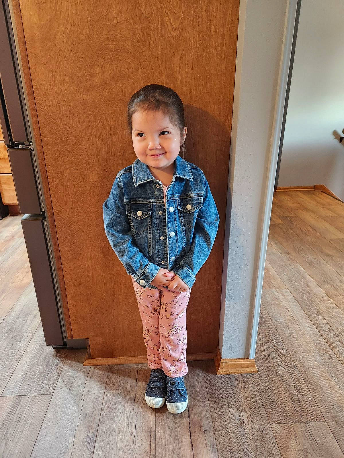 Elianna is registered to the contest to win money with this photo: baby_toddler_clothing, child, collar, denim, electric_blue, floor, flooring, happy, hardwood, joy, pattern, person, plank, sitting, sleeve, smile, toddler, varnish, waist, wood