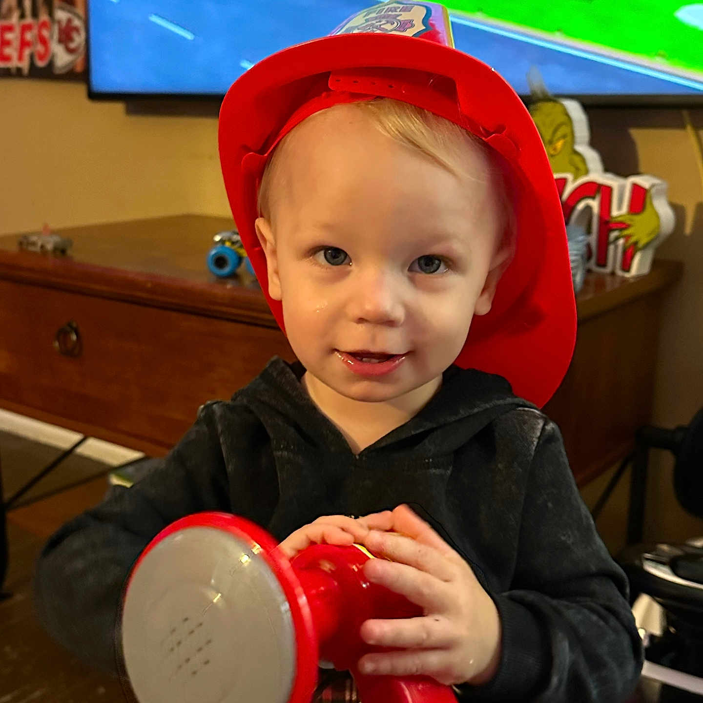 Grayson is registered to the contest to win money with this photo: baby, bodypart, clothing, computerhardware, electronics, face, finger, hand, hardhat, hardware, hat, head, helmet, indoors, interiordesign, monitor, person, photography, portrait, screen