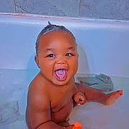 Kamari is registered to the contest to win money with this photo: baby, bath, bathroom, bathtub, child, cute, face, foot, hair, hand, happy, heart_emoji, indoor, orange_toy, playful, skin, smiling, tiled_wall, toy, water