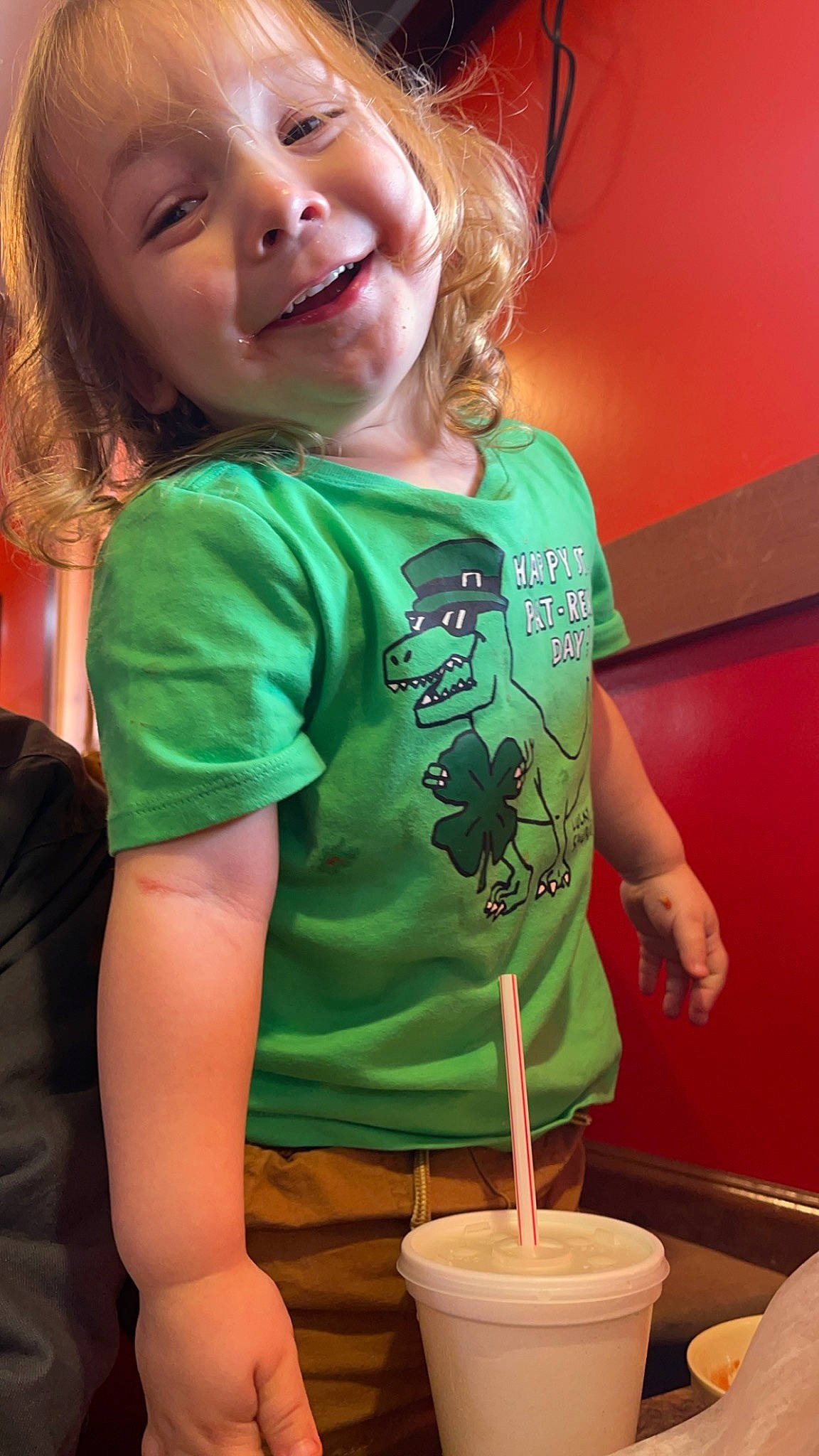 Zander is registered to the contest to win money with this photo: arm, child, comfort_food, cuisine, dish, drink, fun, gesture, green, happy, human_body, joy, laugh, leisure, magenta, person, play, recreation, sleeve, smile