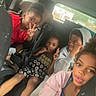 Willie is registered to the contest to win money with this photo: backseat, car, casual_clothing, child, children, dress, gesture, group, hoodie, indoors, jacket, peace_sign, person, portrait, seat, seatbelt, sitting, smile, window, young