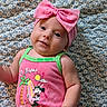 baby, infant, child, pink_bow, headband, minnie_mouse, pink_outfit, sleeveless, patterned_blanket, cute, smiling, portrait, lying_down, closeup, bright_colors, skin, face, arm, hand, eyes