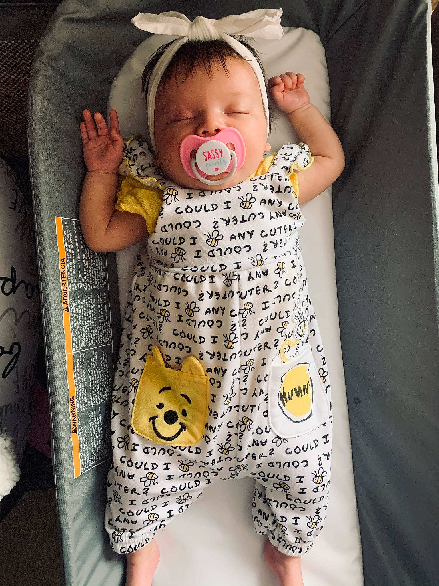 Jamie is registered to the contest to win money with this photo: baby, baby_products, baby_safety, baby_sleeping, baby_toddler_clothing, bag, child, comfort, cool, face, facial_expression, hairstyle, outerwear, pattern, person, photograph, product, sleeve, t_shirt, toddler