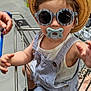 accessories, baby, child, clothing, cute, fashion, floor, hand, hat, metal, pacifier, person, retail, shopping, shopping_cart, store, striped_overalls, sunglasses, supermarket, toddler