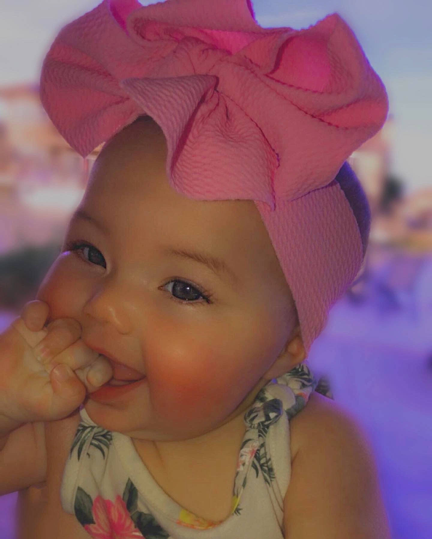 Hudsyn is registered to the contest to win money with this photo: baby, bonnet, cheek, child, ear, face, fashion_accessory, forehead, hair_accessory, hat, head, headgear, headwear, lip, neck, nose, person, pink, purple, skin