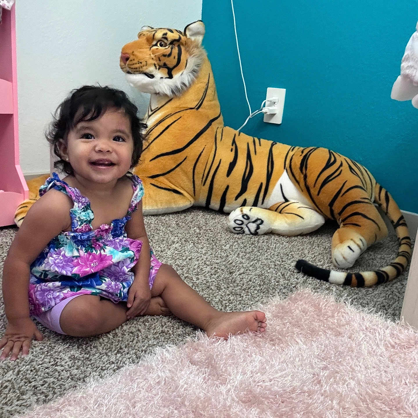 Jasmine joined the competition — help win amazing prizes! blue, carpet, child, colorful_clothing, cute, floor, furniture, hair, happy, indoor, person, pink, plush_toy, room, sitting, smiling, tiger, toddler, toy, wall