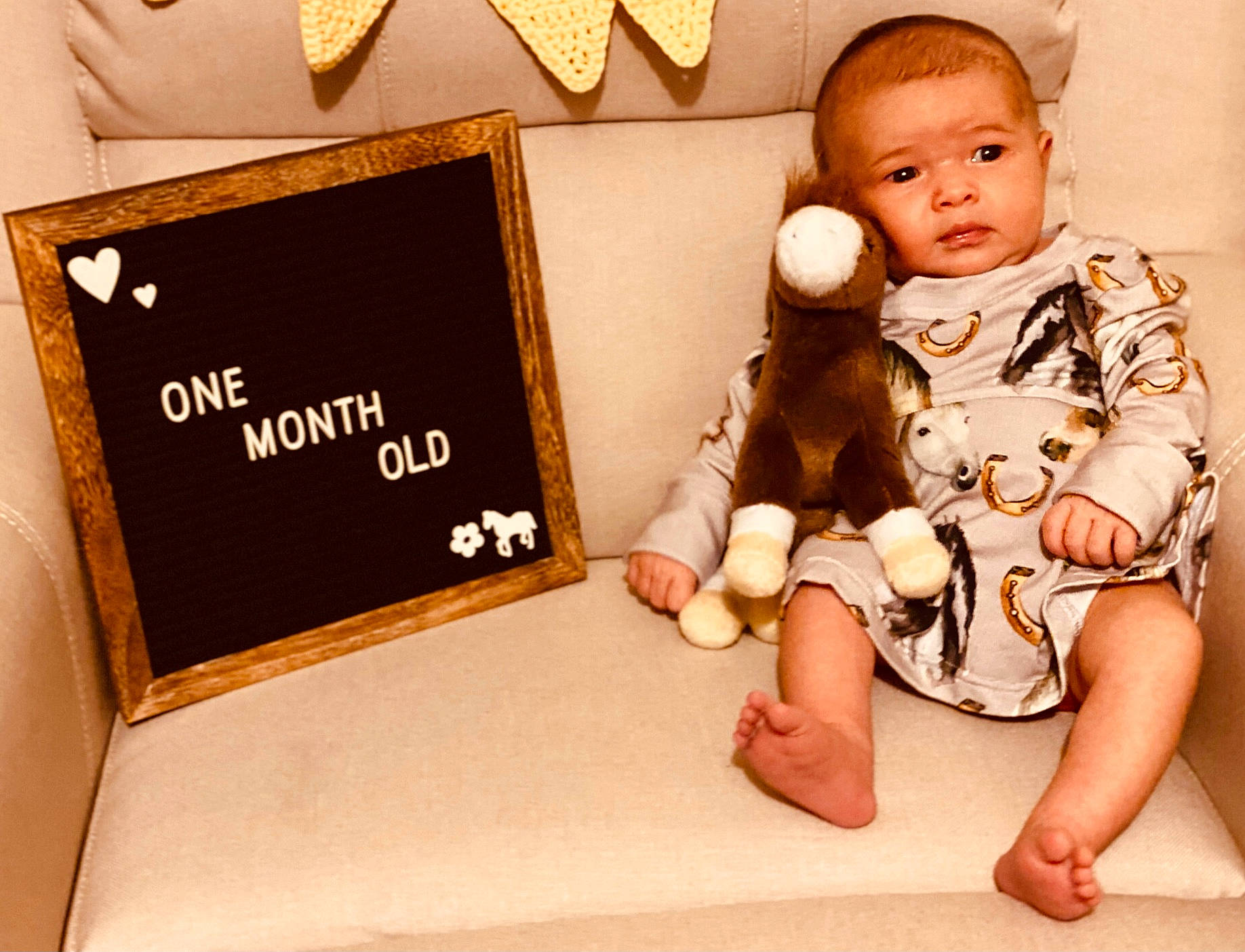 Ellie is registered to the contest to win money with this photo: baby, baby_sleeping, baby_toddler_clothing, barefoot, child, comfort, doll, flooring, foot, fur, happy, linens, person, rectangle, room, sitting, sleeve, stuffed_toy, toddler, toy