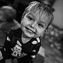 Daxton is registered to the contest to win money with this photo: black_and_white, blurred_background, child, clothing, cute, expression, eyes, face, floor, hair, happy, indoors, joy, pajamas, person, portrait, sitting, smiling, toddler, young_child
