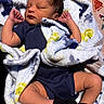 Ezra joined the competition — help win amazing prizes! baby, newborn, sleeping, blanket, blue, onesie, black_socks, infant, cute, peaceful, soft_texture, face, hands, legs, skin, lying_down, indoor, closeup, child, resting