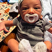 Ezra joined the competition — help win amazing prizes! baby, pacifier, onesie, hat, infant, person, clothing, hand, sock, blanket, fabric, cute, indoor, newborn, portrait, closeup, holding, skin, soft, cozy
