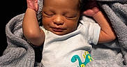 Ezra joined the competition — help win amazing prizes! newborn, baby, sleeping, blanket, clothing, dinosaur, onesie, infant, cute, soft, cozy, portrait, child, wrapped, resting, peaceful, skin, head, hands, warm