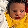 Ezra is registered to the contest to win money with this photo: newborn, baby, infant, face, yellow_towel, close_up, person, skin, hair, eyes, mouth, expression, blanket, fabric, resting, indoor, soft_light, portrait, young_child, human
