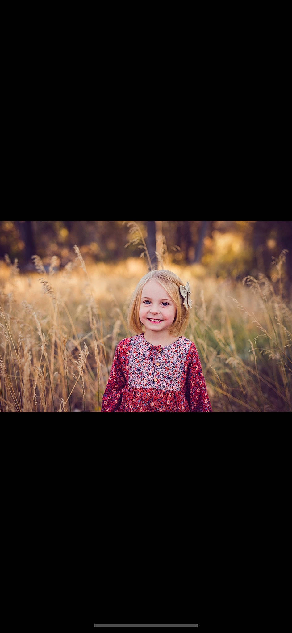 Paisley is registered to the contest to win money with this photo: blond, child, dress, eye, facial_expression, flash_photography, grass, grass_family, happy, joy, people_in_nature, person, photograph, photography, portrait, portrait_photography, sitting, sky, smile, sunlight
