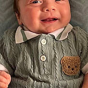 Harrison is registered to the contest to win money with this photo: baby, smiling, infant, knitted_clothing, teddy_bear_patch, cute, happy, portrait, child, cozy, buttoned_shirt, texture, soft_blanket, closeup, young_child, face, hand, casual, indoors, cute_expression