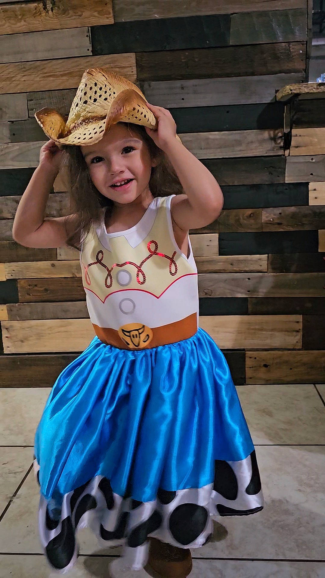 Annabella is registered to the contest to win money with this photo: arm, cool, cowboy_hat, dress, electric_blue, event, face, facial_expression, fun, happy, hat, headgear, headwear, joy, pattern, person, photograph, pink, sombrero, sun_hat