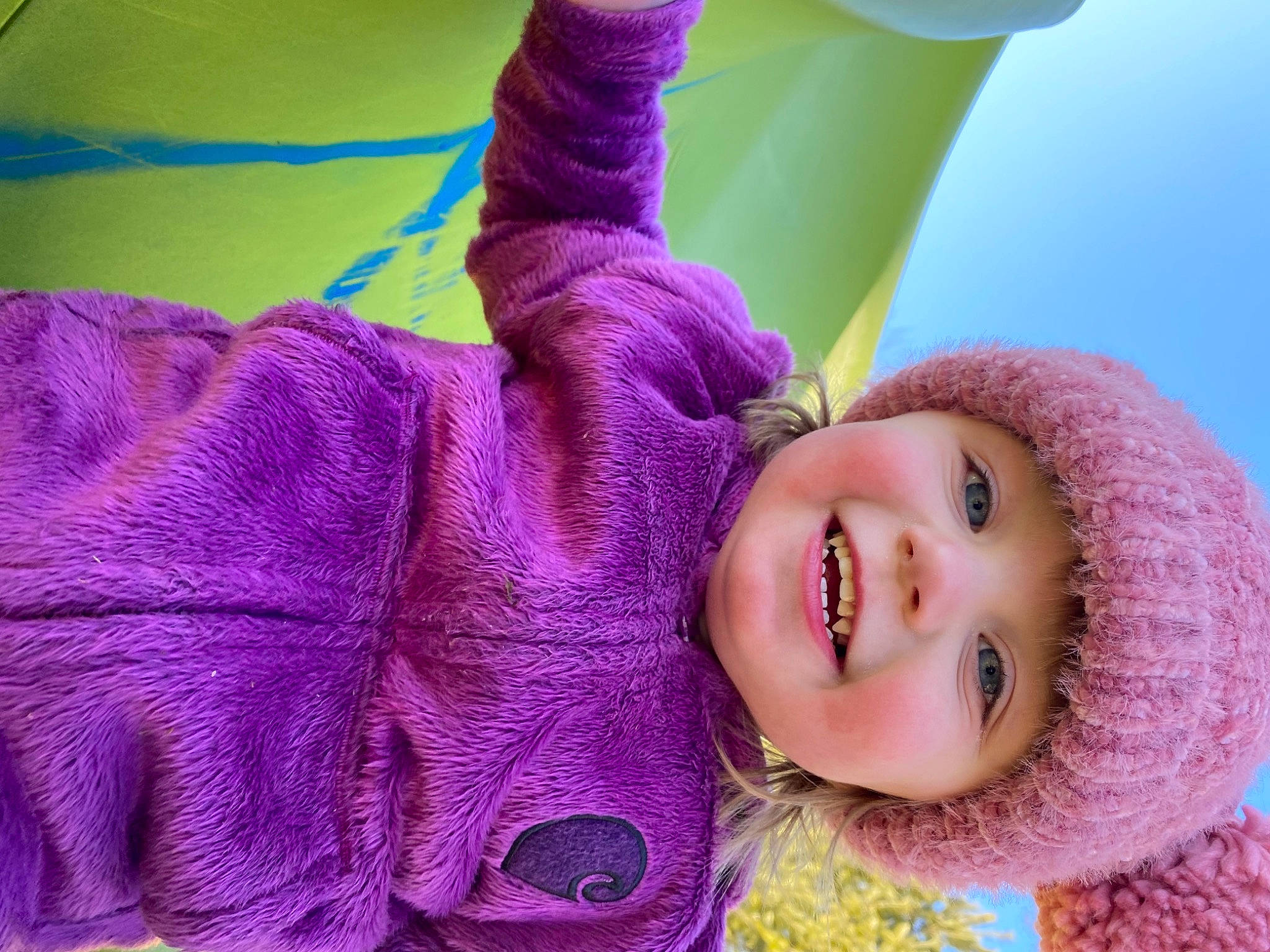Annabella is registered to the contest to win money with this photo: baby, baby_toddler_clothing, child, happy, hat, headwear, human_body, joy, leisure, lip, magenta, outerwear, person, pink, plant, purple, skin, sleeve, smile, textile