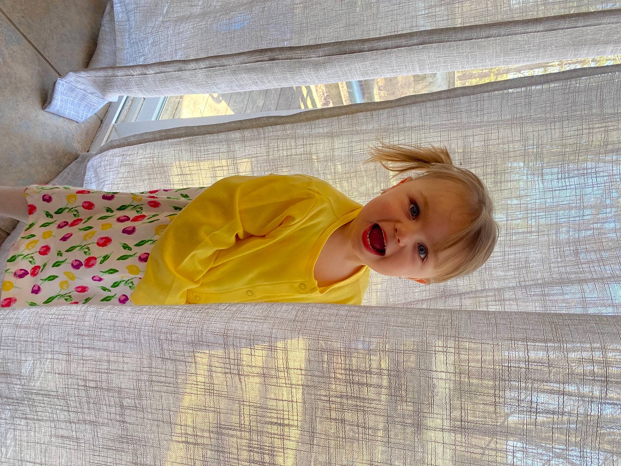 Annabella is registered to the contest to win money with this photo: baby, baby_products, baby_safety, baby_toddler_clothing, child, comfort, floor, flooring, fun, grass, leisure, linens, pattern, person, product, room, smile, textile, toddler, tree