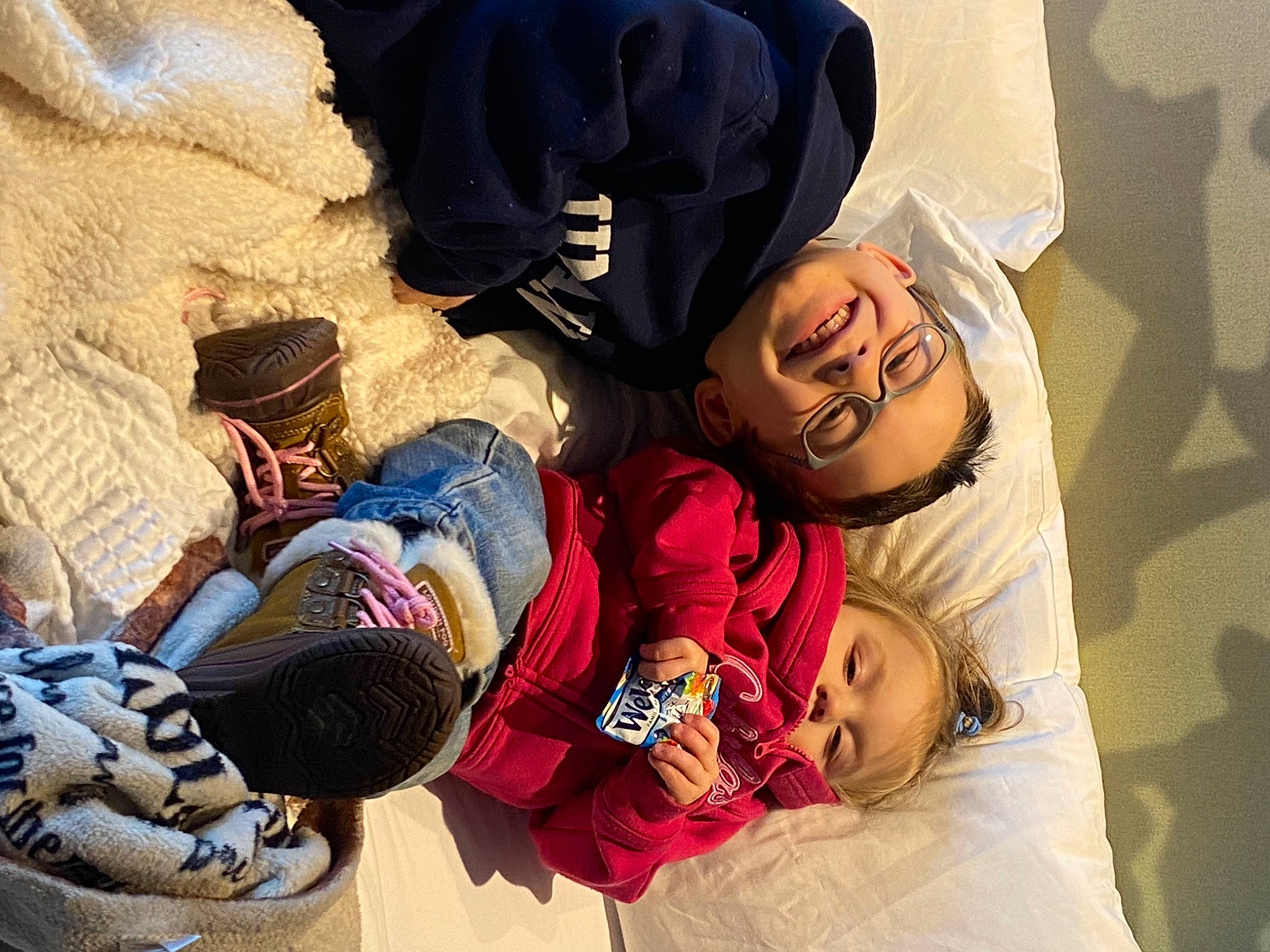 Jaxson is registered to the contest to win money with this photo: backpack, bag, carmine, child, comfort, fun, human, joy, landscape, leisure, linens, luggage_and_bags, mammal, nap, person, room, sitting, textile, thread, toddler