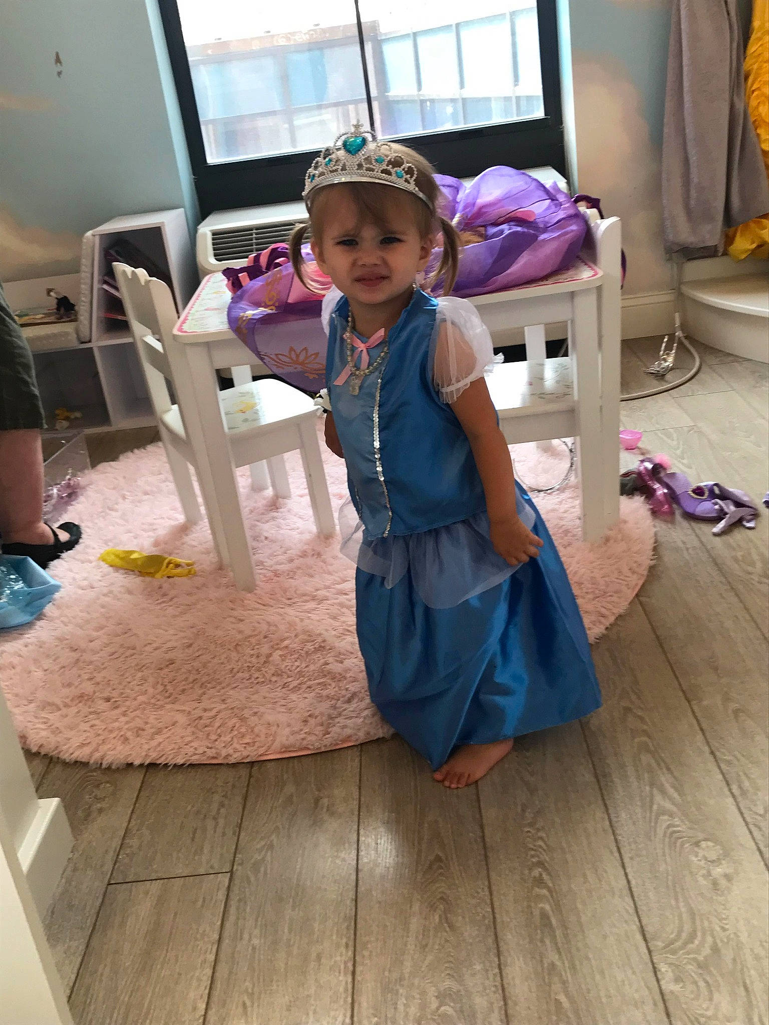 Phoenix is registered to the contest to win money with this photo: baby_toddler_clothing, chair, child, curtain, dress, event, floor, flooring, fun, hardwood, headwear, laminate_flooring, magenta, person, purple, room, sitting, smile, toddler, window
