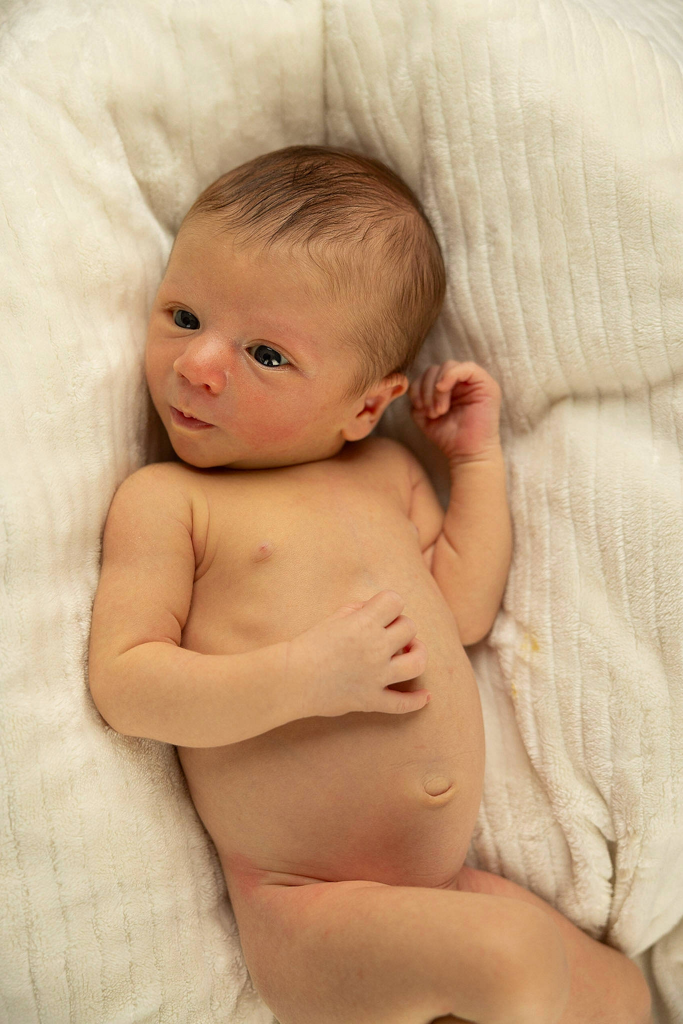 Ashton is registered to the contest to win money with this photo: abdomen, arm, baby, cheek, chest, chin, comfort, eye, face, facial_expression, hand, head, human_body, iris, lip, mouth, neck, nose, person, skin