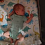 newborn, baby, sleeping, onesie, blanket, pacifier, dinosaur_print, crib, infant, cute, soft_lighting, peaceful, toddler, bedtime, child, rest, indoors, comfort, mattress, teddy_bear_print