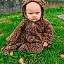 baby, child, grass, outdoor, leopard_print, hoodie, serious_expression, blue_eyes, sitting, nature, greenery, autumn_leaves, cute, animal_print, young_child, portrait, warm_clothing, grass_field, baby_clothing, intense_gaze
