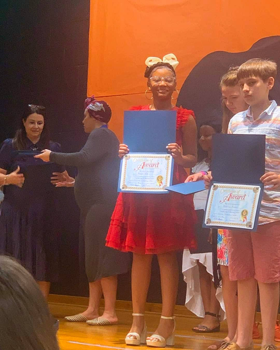 Nayomi is registered to the contest to win money with this photo: award_ceremony, competition, curtain, drama, entertainment, event, fashion_design, fun, hat, heater, joy, performance, performance_art, performing_arts, person, public_event, shorts, smile, stage_equipment, t_shirt