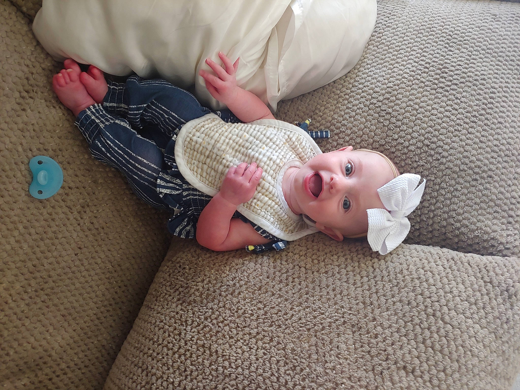 Delta joined the competition — help win amazing prizes! baby, baby_toddler_clothing, child, comfort, finger, flooring, foot, head, headwear, human_body, human_leg, lap, leg, linens, person, pink, skin, sleeve, sock, textile