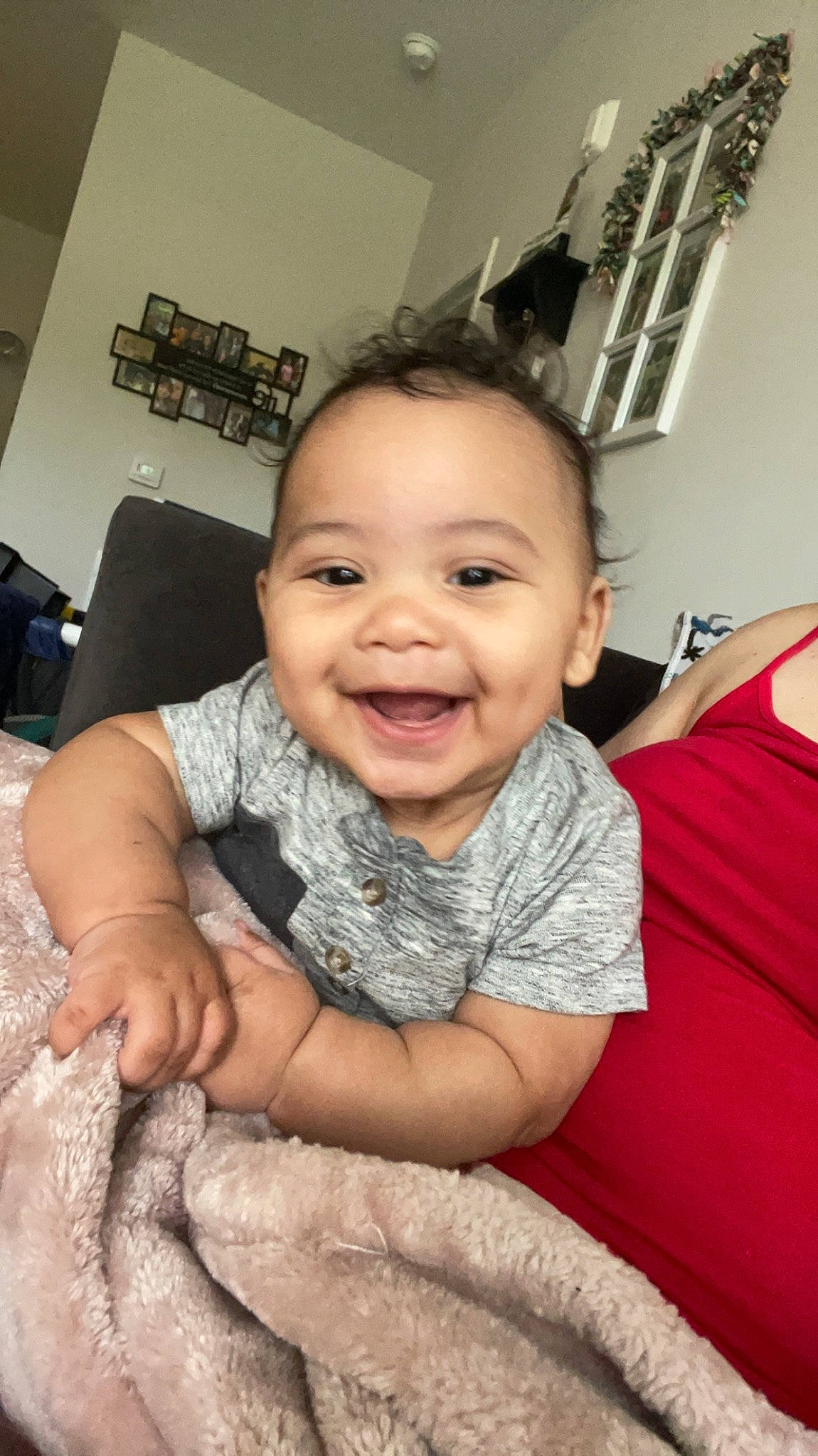 Kylan is registered to the contest to win money with this photo: baby, baby_toddler_clothing, cheek, child, chin, comfort, eyebrow, finger, flash_photography, flooring, fun, happy, iris, joy, person, picture_frame, room, skin, sleeve, smile