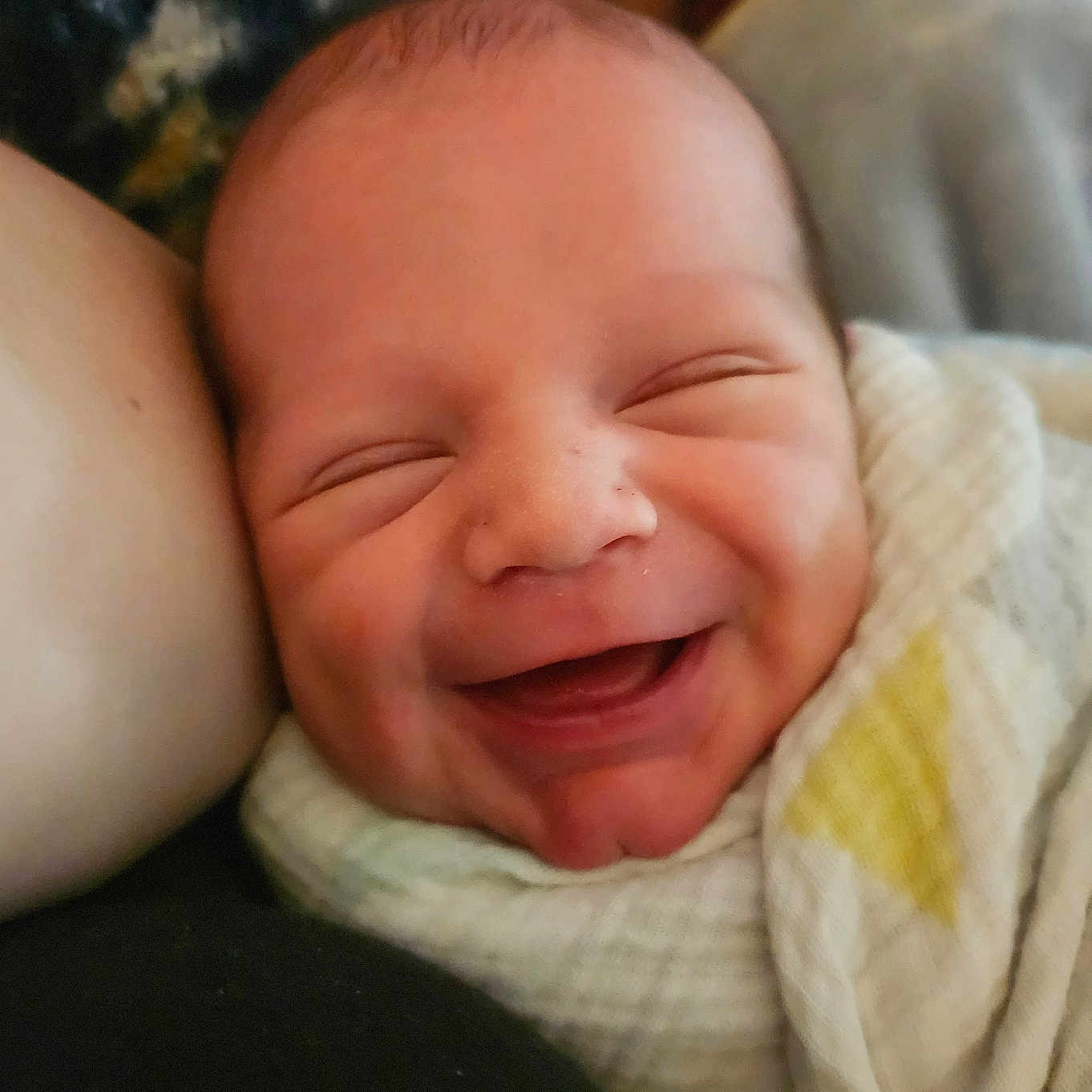 Riley is registered to the contest to win money with this photo: baby, babylaughing, blanket, bodypart, cushion, face, happy, head, homedecor, laughing, mouth, newborn, person, photography, portrait, quilt, sleeping, smile, towel