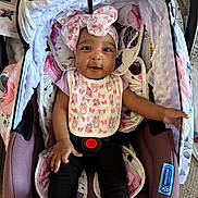 Leilahni joined the competition — help win amazing prizes! baby, infant, car_seat, headband, bow, pink, white, black_pants, socks, floral_pattern, blanket, carrying_handle, fabric, cute, smiling, child, indoor, seat_belt, person, comfort