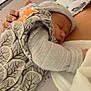 Ilyana participe au concours pour gagner de l'argent avec cette photo : newborn, baby, sleeping, blanket, knitwear, hat, hand, bed, pillow, adult, resting, cozy, hospital, indoor, comfort, closeup, person, infant, soft_lighting, peaceful