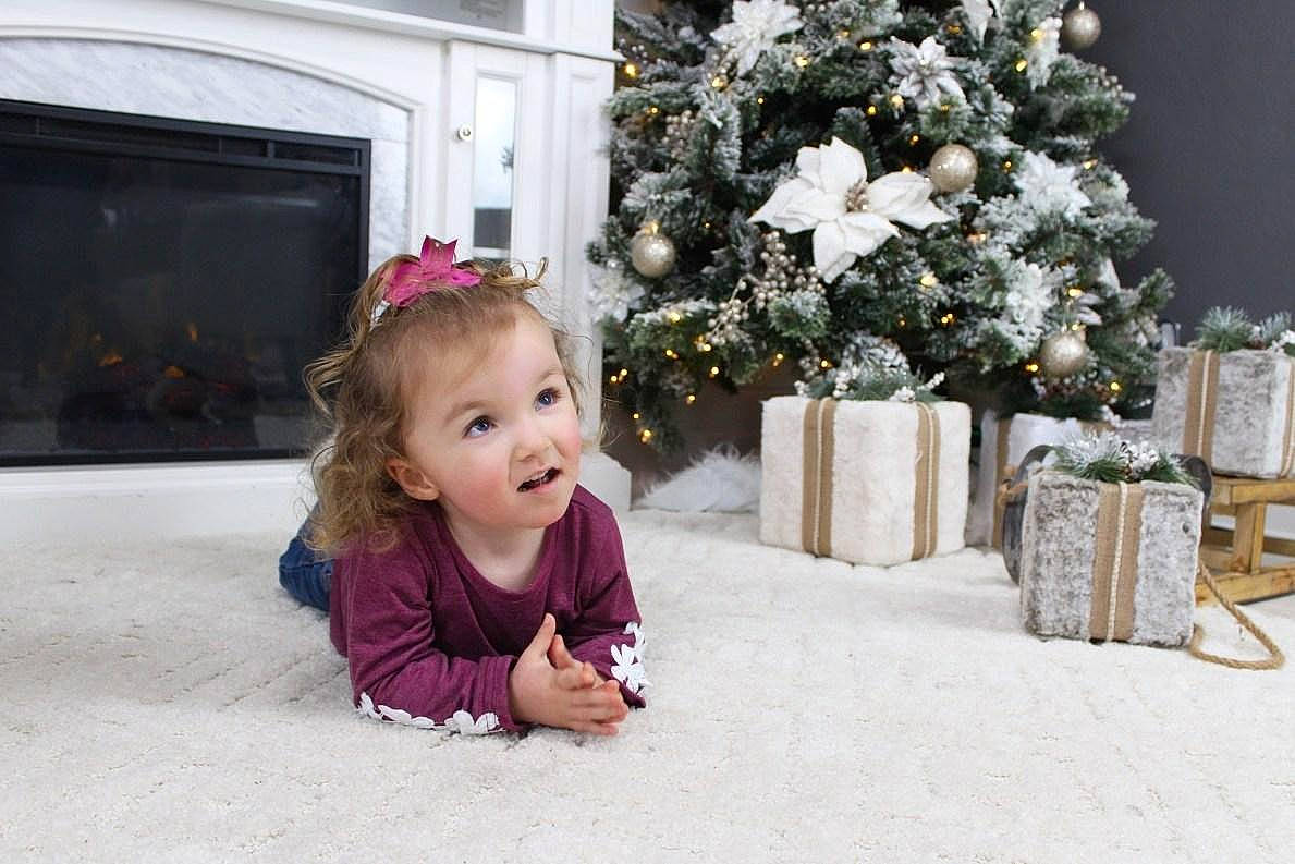 Kenlee joined the competition — help win amazing prizes! baby, baby_toddler_clothing, child, christmas, christmas_decoration, christmas_tree, conifer, evergreen, eye, fire_screen, holiday, home, interior_design, mouth, ornament, person, pine_family, pink, snow, surprise