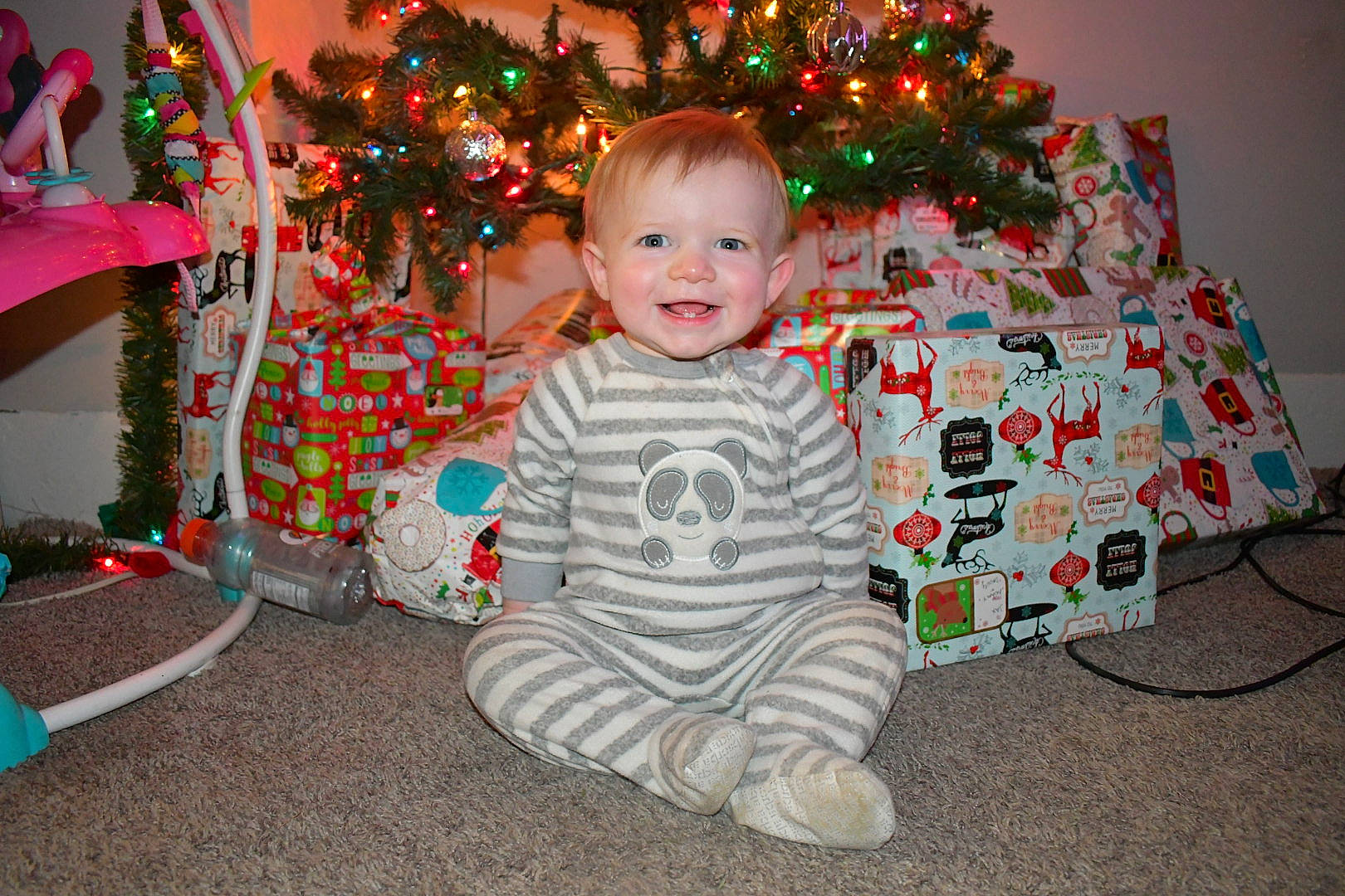 Jaxxon is registered to the contest to win money with this photo: baby, child, christmas, christmas_decoration, christmas_eve, christmas_ornament, christmas_tree, event, facial_expression, fun, happy, holiday, holiday_ornament, joy, lap, ornament, people, person, sitting, smile