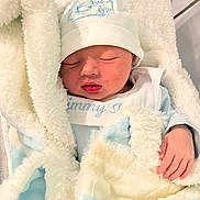 Jimmy Isaiah joined the competition — help win amazing prizes! newborn, baby, sleeping, blanket, hat, hand, cozy, soft, infant, bed, rest, cute, warm, clothing, face, portrait, peaceful, indoor, child, wrapped