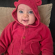 évélina participe au concours pour gagner de l'argent avec cette photo : baby, infant, child, hoodie, red_hoodie, knitwear, cute, big_eyes, smile, sitting, pillow, couch, eyelashes, button, pocket, hand, cozy, portrait, indoor, fabric