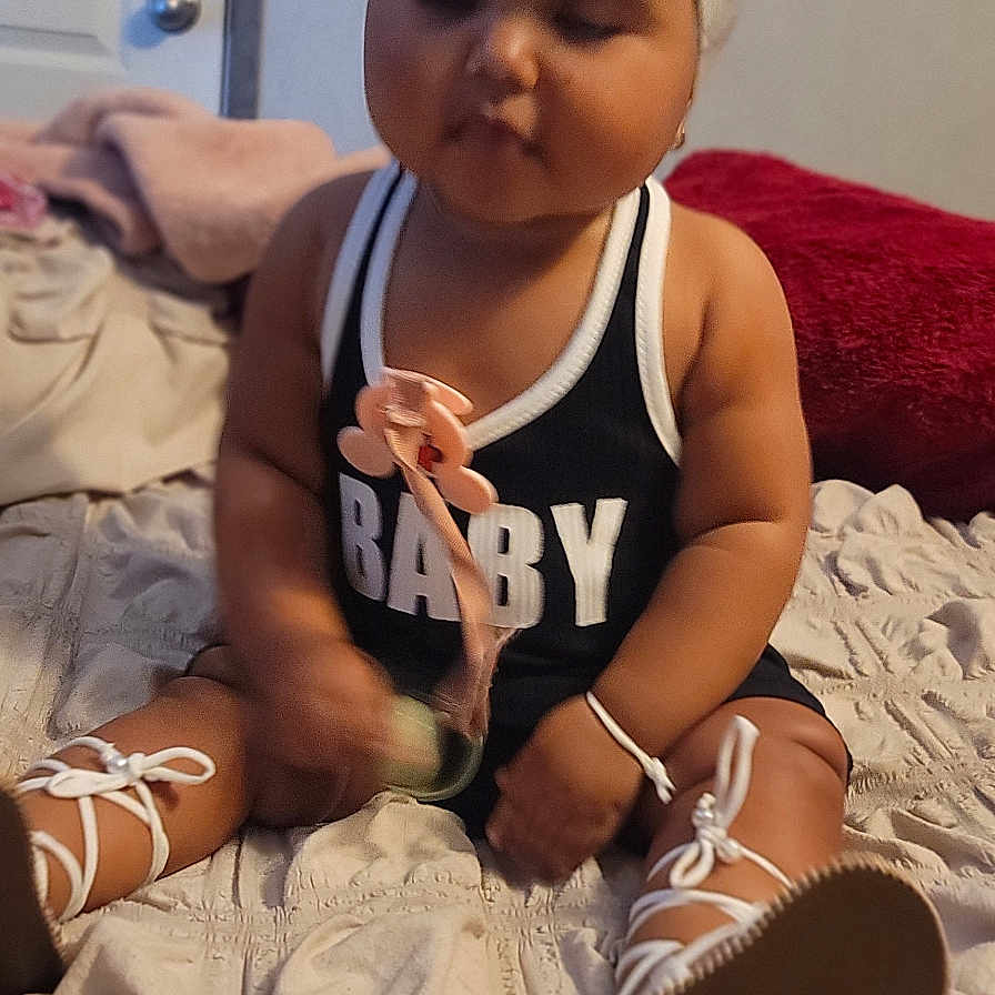 Jaseirys is registered to the contest to win money with this photo: baby, bed, bodypart, clothing, couch, face, finger, footwear, furniture, hand, hat, head, person, photography, portrait, sandal, shoe, shorts, sitting, sneaker