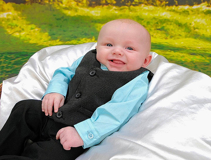 Tanner is registered to the contest to win money with this photo: baby_products, boy, child, fun, grass, infant, joy, outerwear, person, photograph, portrait_photography, product, sitting, smile, toddler