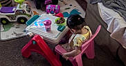 Katalayiah joined the competition — help win amazing prizes! blanket, bowl, carpet, carpeted_floor, child, hair_tie, indoor, living_room, pink_chair, plastic_chair, plastic_table, playroom, quiet_moment, ride_on_toy, sippy_cup, sofa, table, toddler, toy, yellow_clothing
