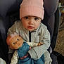 baby, beanie, big_eyes, bottle, car_seat, carpet, child, clothing, doll, earrings, hands, hoodie, indoor, pink_hat, portrait, reebok_logo, sitting, toddler, toy, zipper