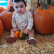 Katalayiah is registered to the contest to win money with this photo: toddler, child, pumpkin, straw, fall, autumn, gourd, headband, outdoor, baby_clothing, cute, seasonal, harvest, orange, sitting, small_gourd, expression, holiday, decor, young_child