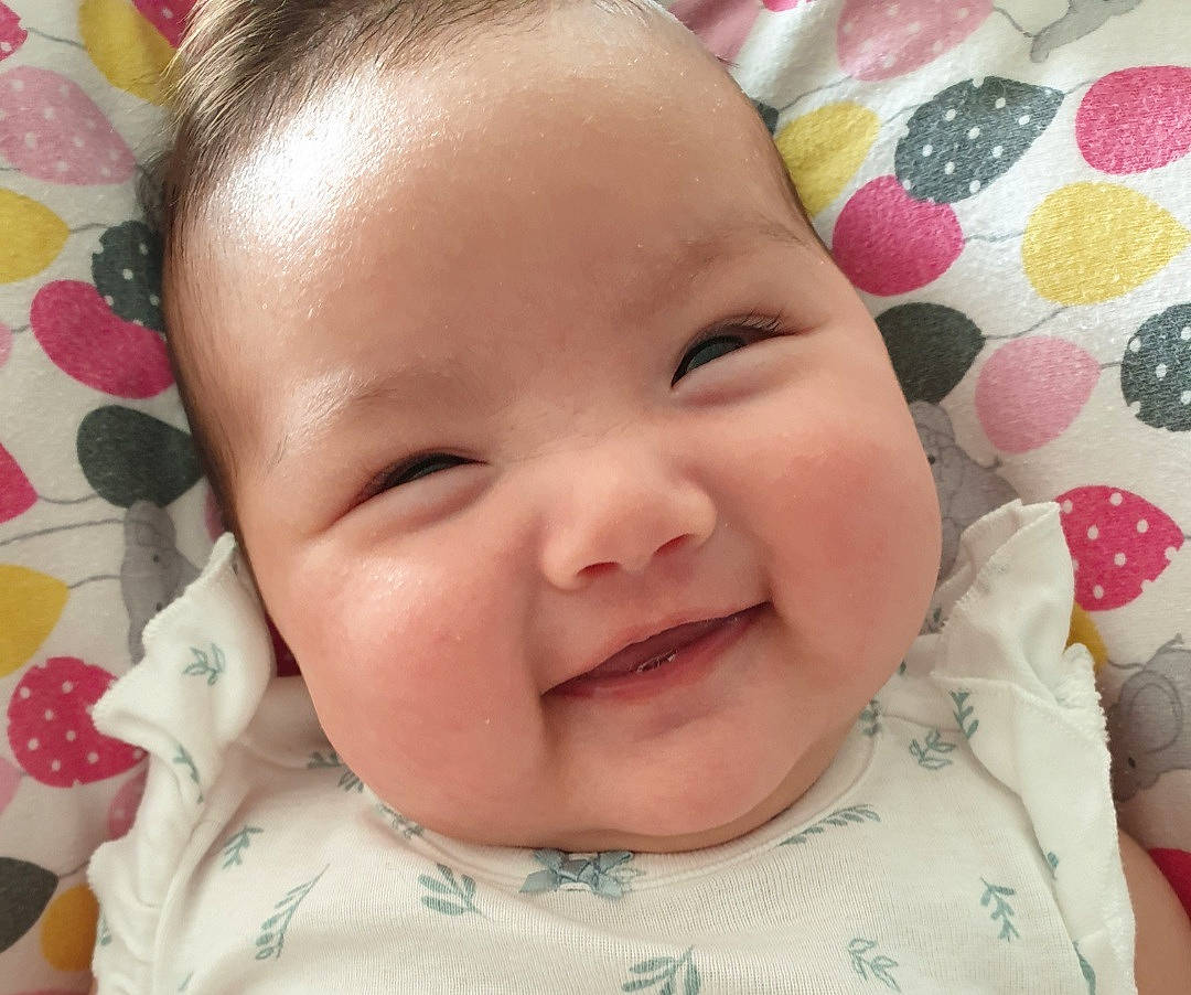 Jamie is registered to the contest to win money with this photo: baby, baby_toddler_clothing, cheek, chin, ear, eyebrow, eyelash, facial_expression, happy, head, iris, lip, mouth, nose, organ, person, skin, sleeve, smile, textile