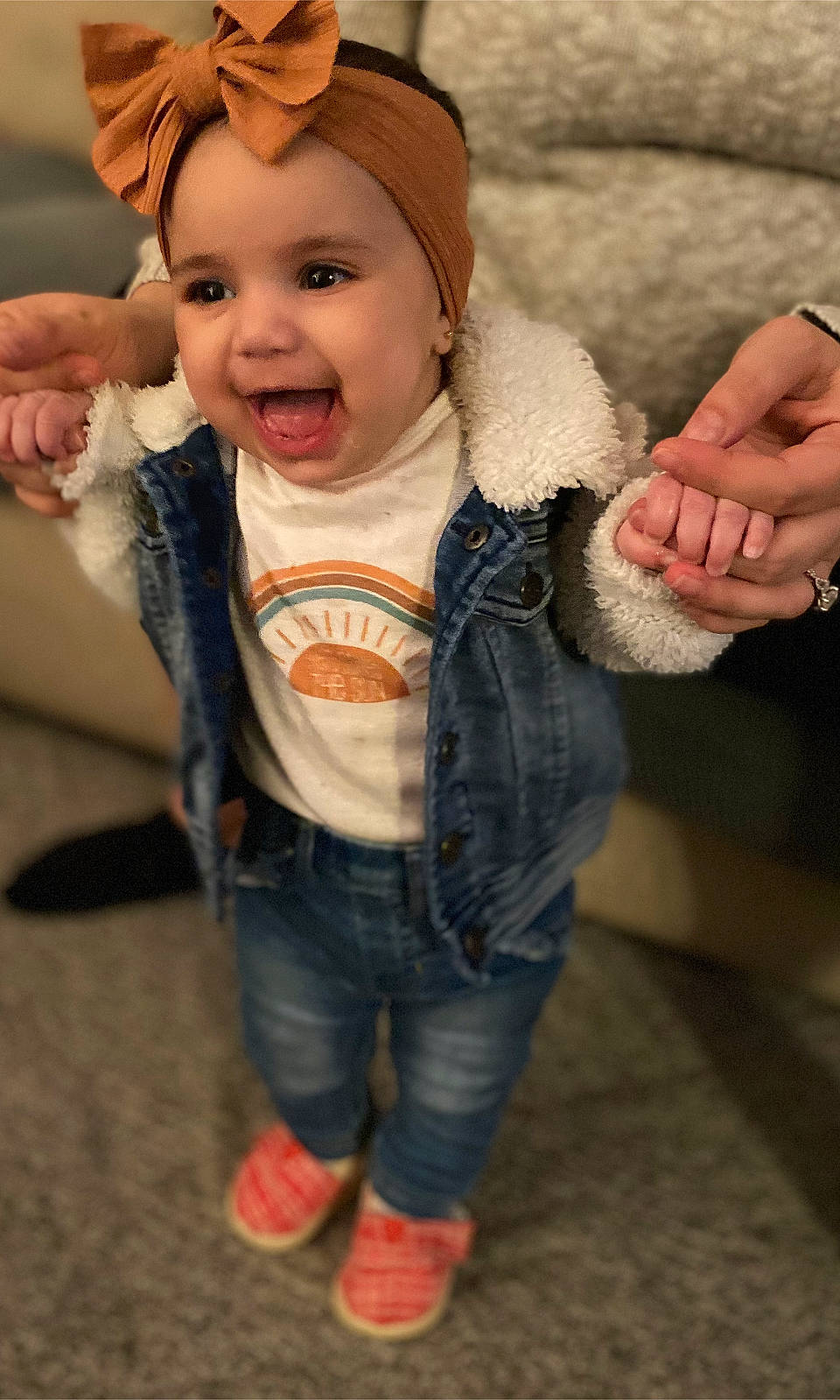 Rosalynn is registered to the contest to win money with this photo: baby, baby_toddler_clothing, cap, cheek, eye, face, finger, fun, gesture, happy, head, headgear, headwear, human_body, iris, person, skin, sleeve, smile, standing